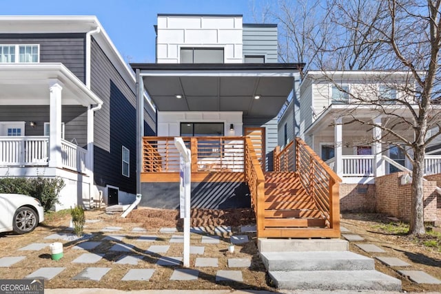view of front of house featuring covered porch, stairway, and cooling unit
