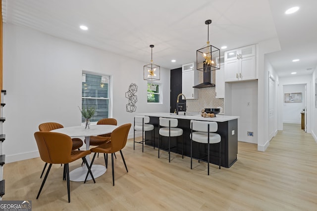 906 Mcdaniel St, Atlanta, GA 30310 - kitchen with light wood-style floors, light countertops, recessed lighting, white cabinetry, and tasteful backsplash