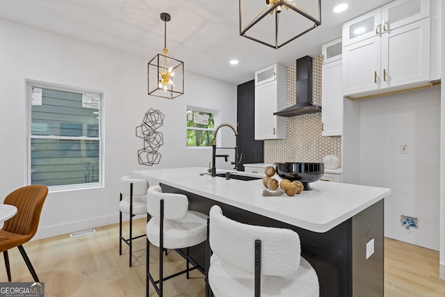 906 Mcdaniel St, Atlanta, GA 30310 - kitchen featuring wall chimney exhaust hood, white cabinets, light wood-type flooring, backsplash, and recessed lighting