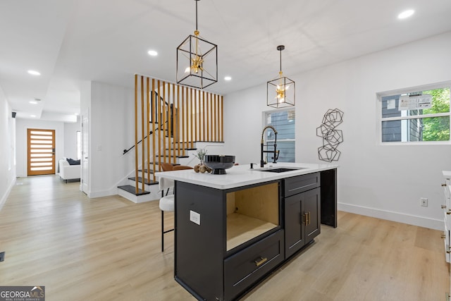 906 Mcdaniel St, Atlanta, GA 30310 - kitchen featuring a sink, light wood-style flooring, light countertops, baseboards, and plenty of natural light