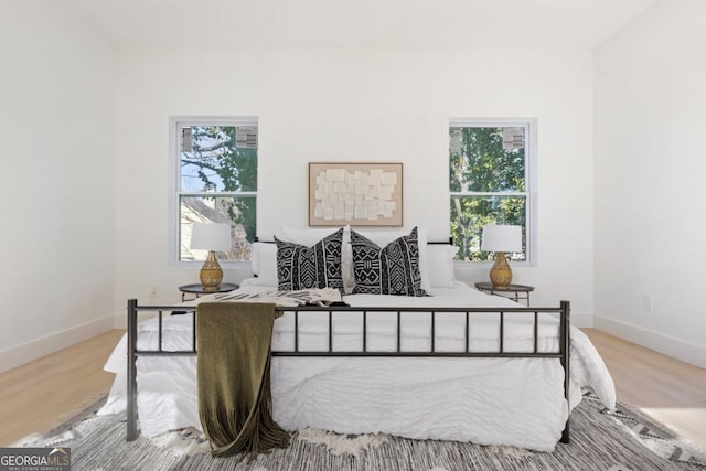 bedroom featuring baseboards and wood finished floors