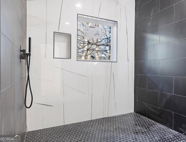 bathroom with a tile shower