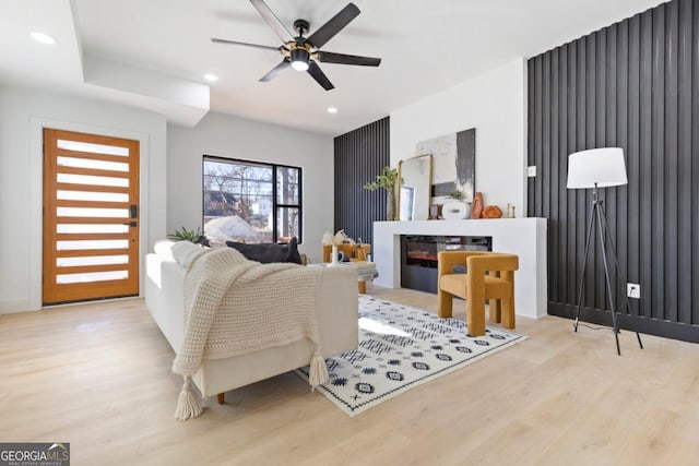 living room featuring recessed lighting, a ceiling fan, and wood finished floors