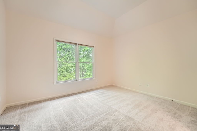 unfurnished room with baseboards and light colored carpet