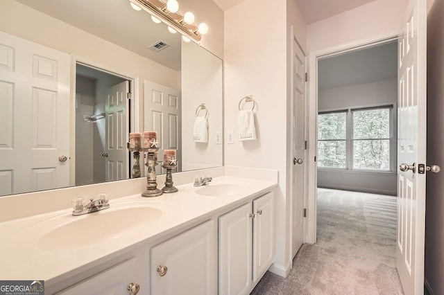 full bath featuring visible vents, a sink, and double vanity