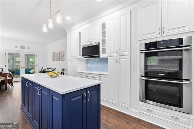 100 Barnard Pl, Atlanta, GA 30328 - kitchen with white cabinetry, appliances with stainless steel finishes, blue cabinets, french doors, and hanging light fixtures