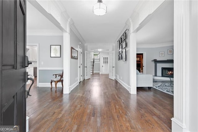 100 Barnard Pl, Atlanta, GA 30328 - foyer with ornamental molding, dark wood-style floors, baseboards, and a warm lit fireplace