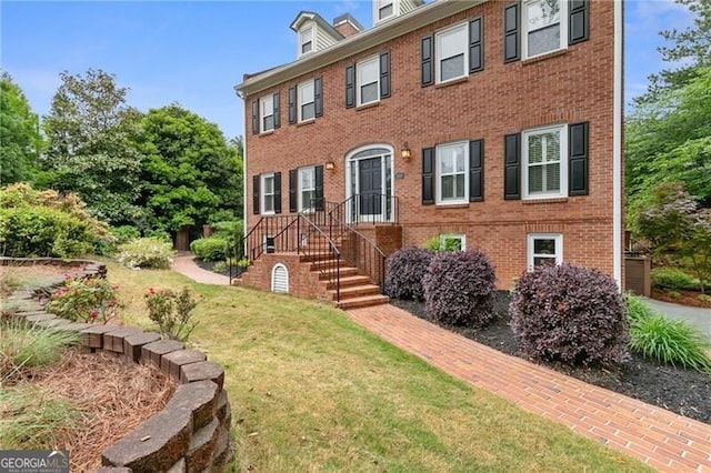 100 Barnard Pl, Atlanta, GA 30328 - colonial inspired home with a front lawn and brick siding