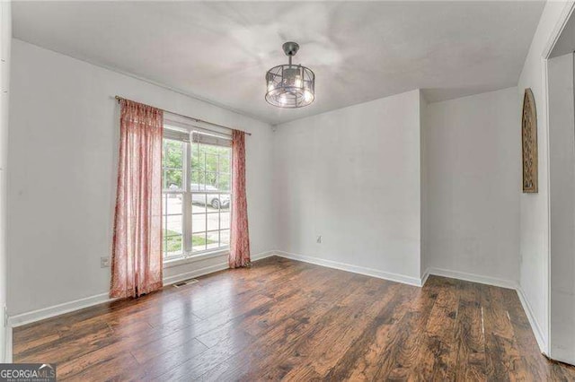 460 Broad St, Tallapoosa, GA 30176 - spare room with wood finished floors and a chandelier