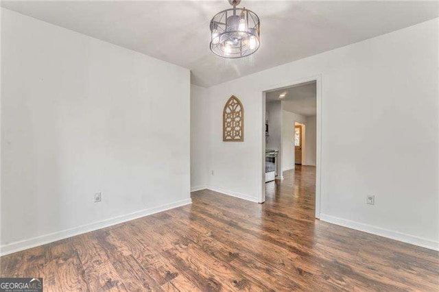 460 Broad St, Tallapoosa, GA 30176 - unfurnished room featuring wood finished floors and a chandelier