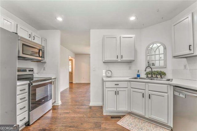 460 Broad St, Tallapoosa, GA 30176 - kitchen with appliances with stainless steel finishes, light countertops, dark wood-type flooring, and recessed lighting
