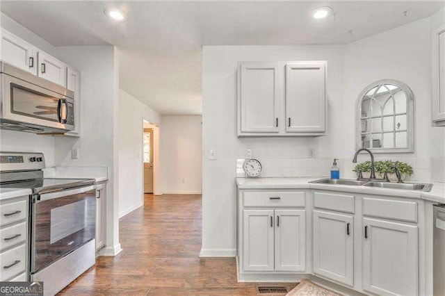 460 Broad St, Tallapoosa, GA 30176 - kitchen featuring stainless steel appliances, light countertops, wood finished floors, recessed lighting, and white cabinets