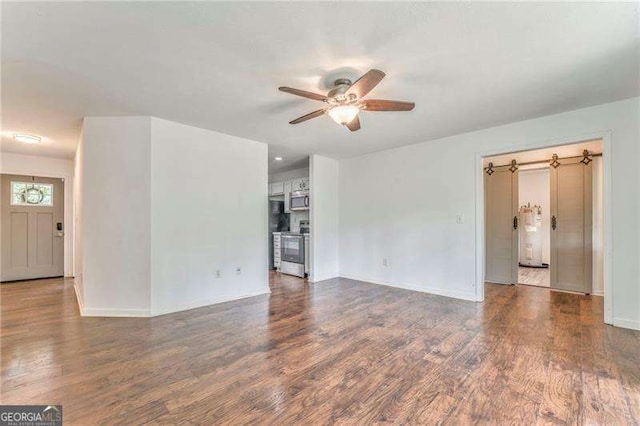 460 Broad St, Tallapoosa, GA 30176 - unfurnished living room with ceiling fan, water heater, and wood finished floors