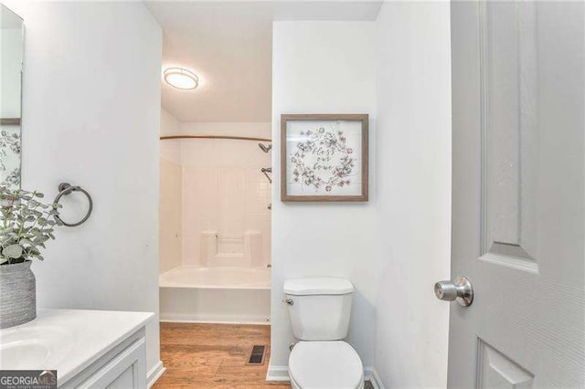 460 Broad St, Tallapoosa, GA 30176 - bathroom with wood finished floors, vanity, and bathtub / shower combination