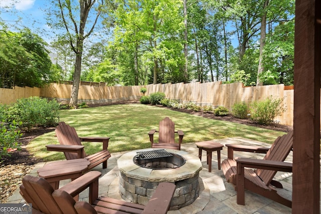 exterior space featuring a fenced backyard, a fire pit, and a patio area