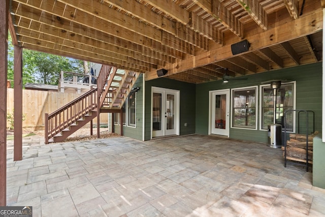 view of patio featuring fence, stairs, and french doors