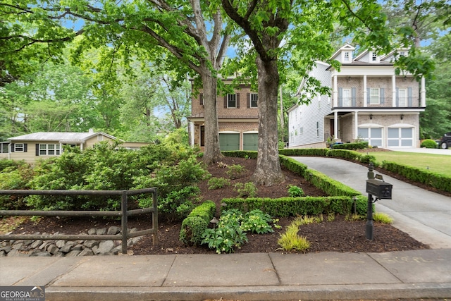 view of property with an attached garage and concrete driveway