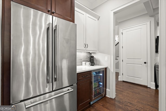 bar with backsplash, dark wood-style floors, high end refrigerator, and wine cooler
