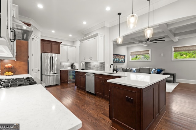 kitchen with light countertops, a ceiling fan, appliances with stainless steel finishes, and a sink