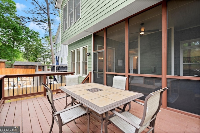 wooden deck featuring outdoor dining area and fence