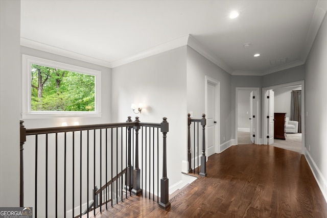 corridor featuring recessed lighting, baseboards, an upstairs landing, wood finished floors, and ornamental molding