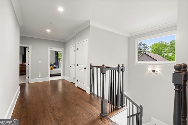 hallway with recessed lighting, an upstairs landing, ornamental molding, and wood finished floors