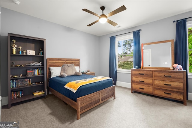 bedroom with carpet flooring, a ceiling fan, and baseboards