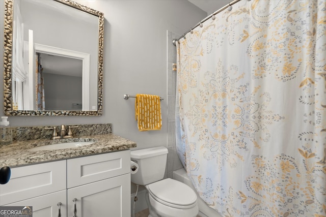 full bathroom featuring vanity, shower / bath combination with curtain, and toilet