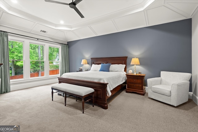 carpeted bedroom with a ceiling fan and visible vents