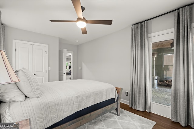 bedroom featuring baseboards, a ceiling fan, and wood finished floors