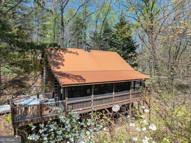 191 Mountain View Rd, Ellijay, GA 30540 - view of front of house featuring a wooden deck, a hot tub, metal roof, and a sunroom