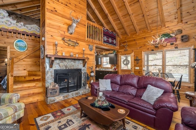 191 Mountain View Rd, Ellijay, GA 30540 - living area featuring wood ceiling with exposed beams, hardwood / wood-style floors, wood walls, a fireplace, and high vaulted ceiling