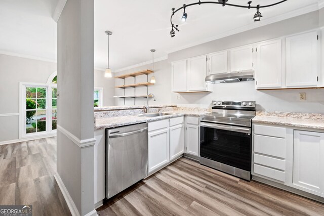 3765 Windsor Cir, Clarkston, GA 30021 - kitchen with under cabinet range hood, appliances with stainless steel finishes, white cabinets, a sink, and crown molding