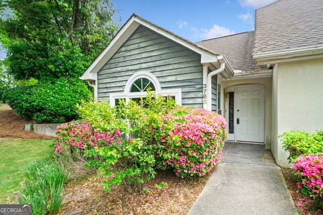 3765 Windsor Cir, Clarkston, GA 30021 - view of exterior entry with stucco siding and roof with shingles