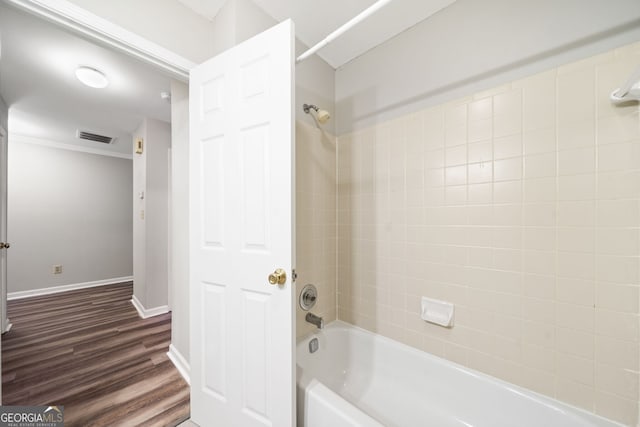 3765 Windsor Cir, Clarkston, GA 30021 - bathroom with wood finished floors, bathing tub / shower combination, baseboards, visible vents, and crown molding