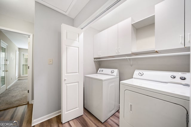 3765 Windsor Cir, Clarkston, GA 30021 - washroom featuring baseboards, washer and dryer, cabinet space, and wood finished floors