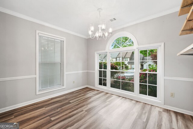 3765 Windsor Cir, Clarkston, GA 30021 - unfurnished dining area with ornamental molding, an inviting chandelier, wood finished floors, and baseboards