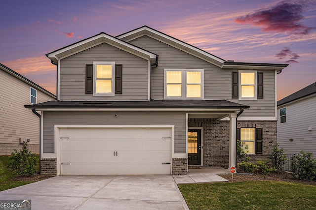traditional-style house featuring brick siding, an attached garage, driveway, and fence