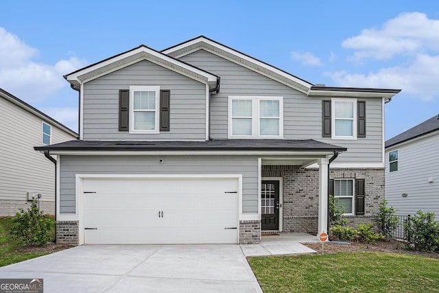 craftsman inspired home featuring a garage, concrete driveway, and brick siding