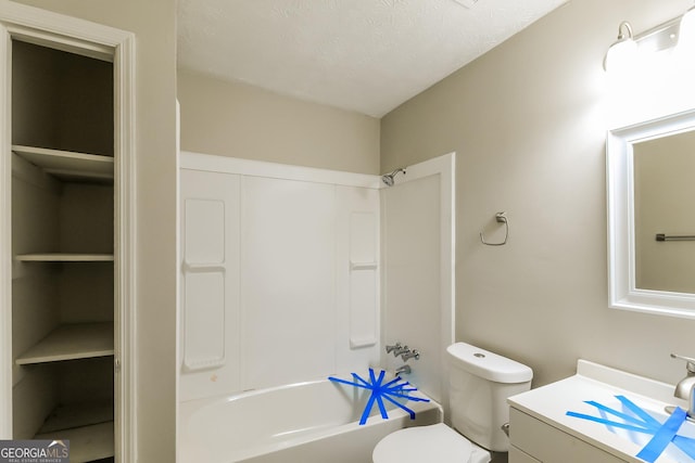 bathroom with washtub / shower combination, toilet, a textured ceiling, and vanity