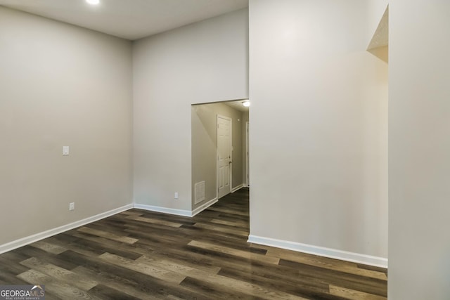 empty room with visible vents, recessed lighting, dark wood finished floors, and baseboards