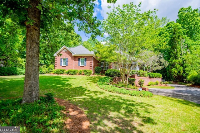 ranch-style home with brick siding and a front lawn