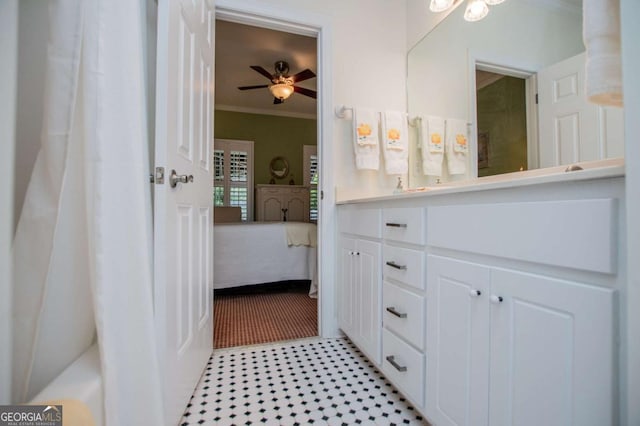 ensuite bathroom featuring vanity, ornamental molding, ensuite bath, and ceiling fan