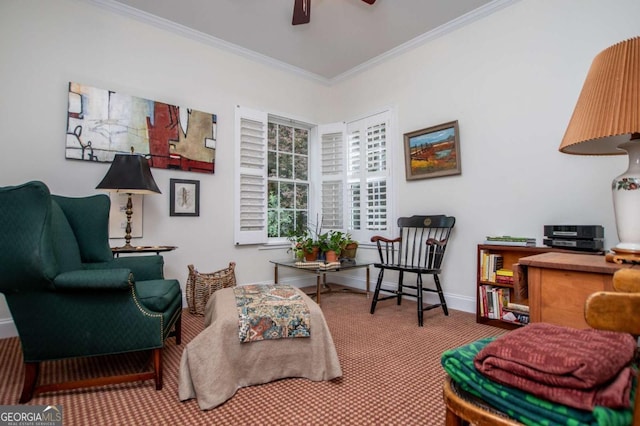 living area featuring a ceiling fan, baseboards, ornamental molding, and carpet