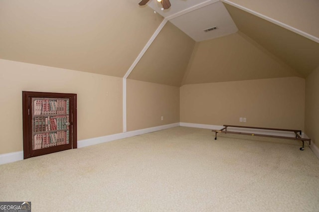 additional living space featuring carpet flooring, a ceiling fan, baseboards, vaulted ceiling, and visible vents