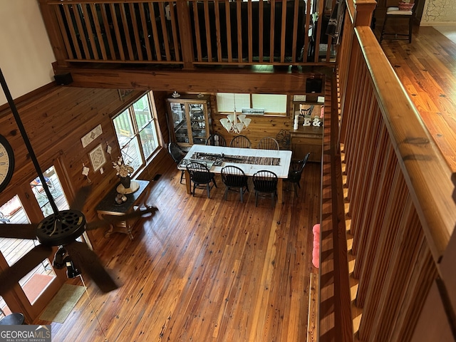 living area with wooden walls and hardwood / wood-style flooring