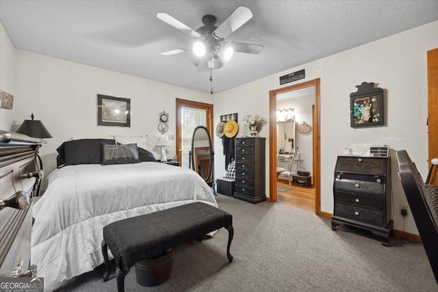 carpeted bedroom featuring a ceiling fan, a textured ceiling, and connected bathroom