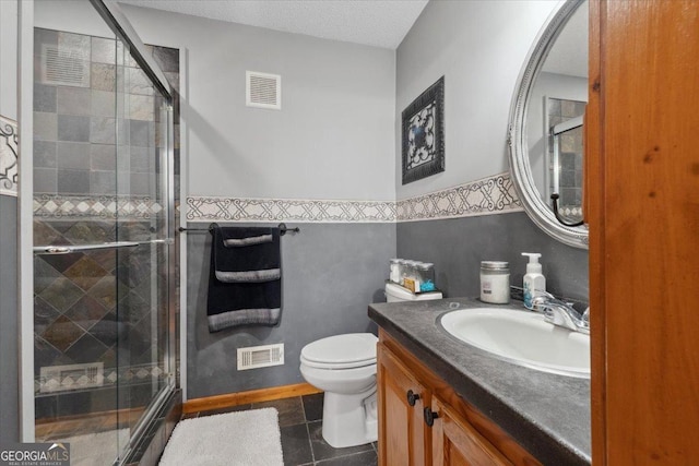 bathroom featuring tile patterned floors, visible vents, a stall shower, and vanity