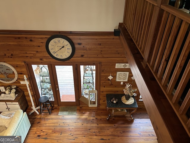 entryway with wood walls and wood finished floors