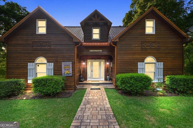 log-style house with a front lawn